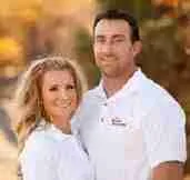 Couple smiling together outdoors in autumn.
